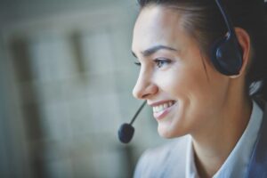 close up of a smiling woman with a headset